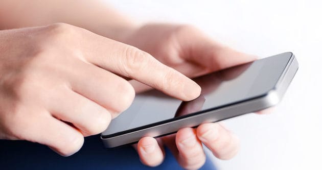 Girl hand touching screen on modern mobile smart phone. Close-up image with shallow depth of field focus on finger.